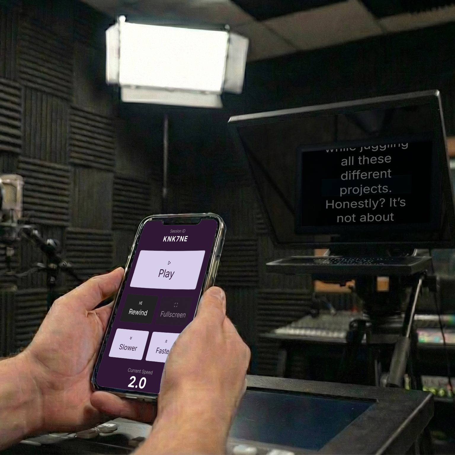 A phone being used as a remote control for a larger screen with a teleprompter.